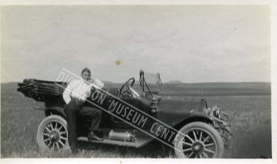 Photo of Fred Maser Jr. Leaning Against an Automobile. 1910-11