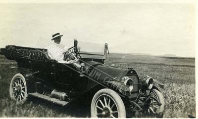 Photo of Victor Maser in the front seat of an automobile. 1910-11.