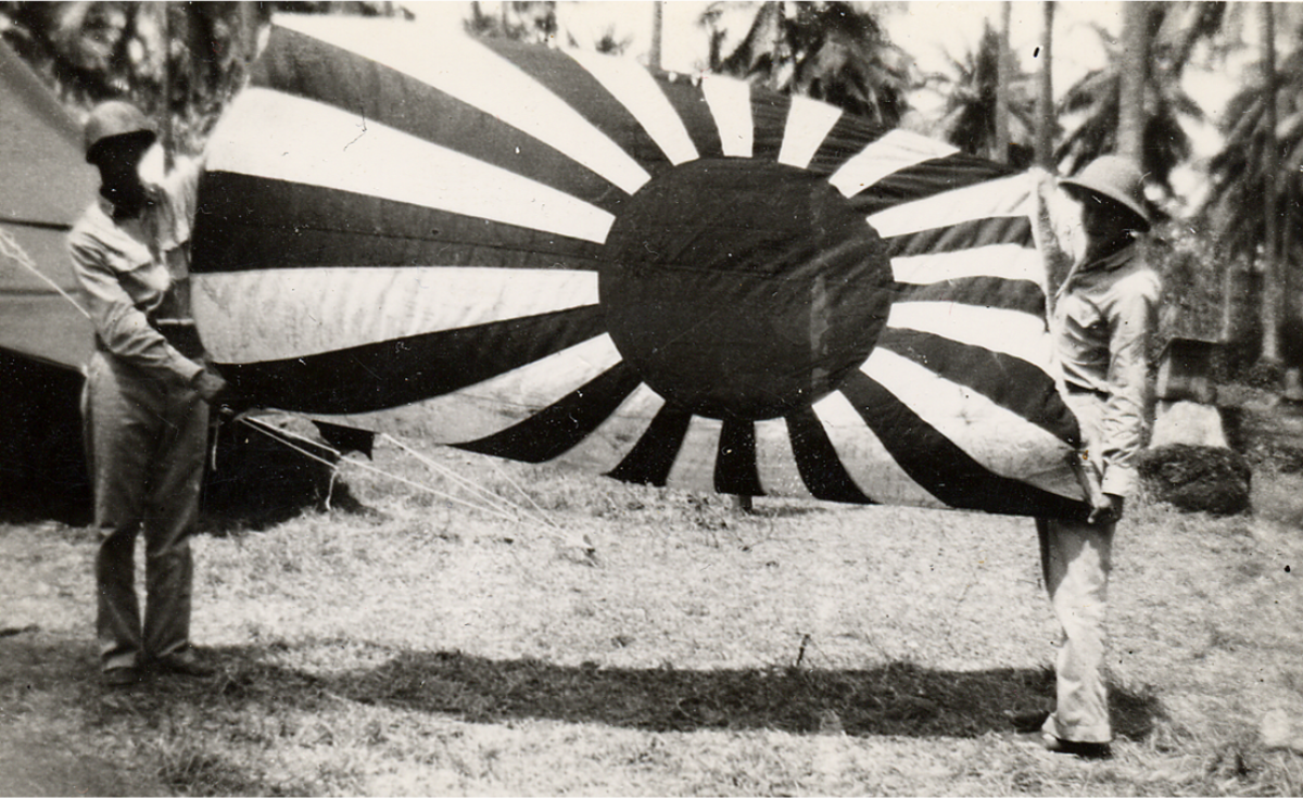 Soldiers From The 164th Infantry Regiment Display A Captured Japanese Flag.